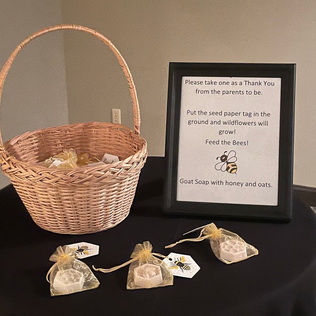 seed paper bee hexagon tags attached to soap favors on a table display