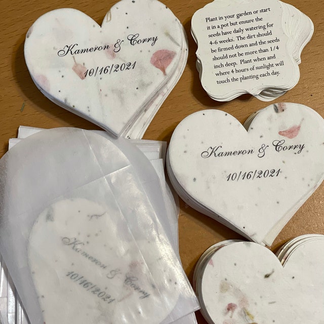 seed paper hearts with bride and groom names and wedding date