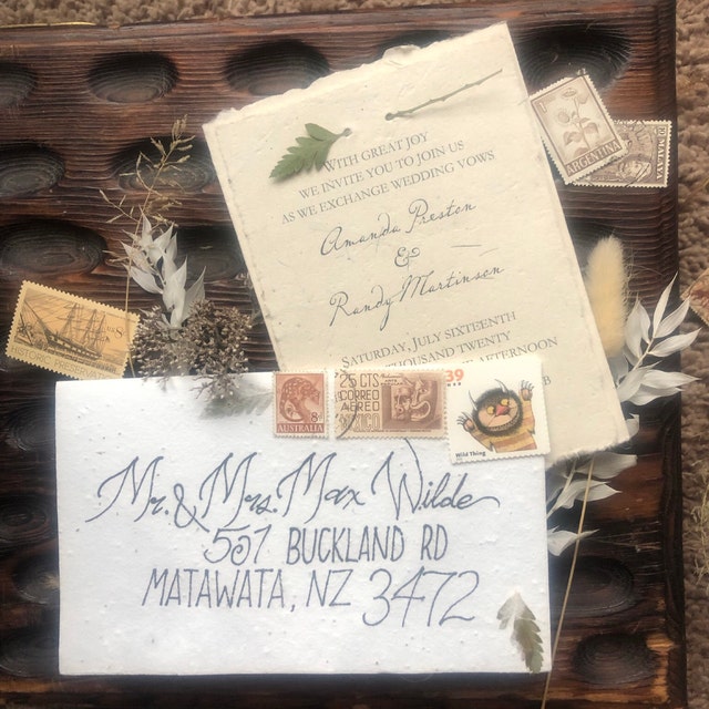 Seed paper invitation for the wedding of Amanda and Randy with envelope being mailed to Matawata, New Zealand