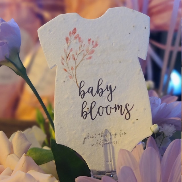 seed paper baby bloom onesie closeup in floral display